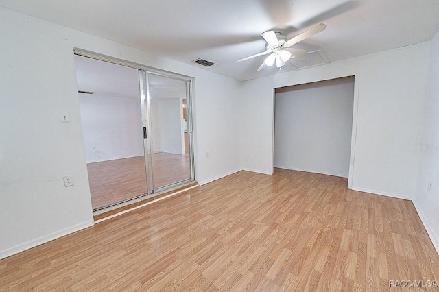 spare room featuring visible vents, baseboards, light wood-style floors, and ceiling fan