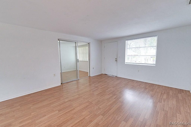 interior space with light wood-style flooring and baseboards