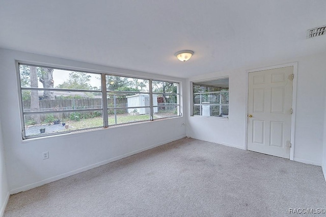 unfurnished sunroom featuring visible vents and a healthy amount of sunlight