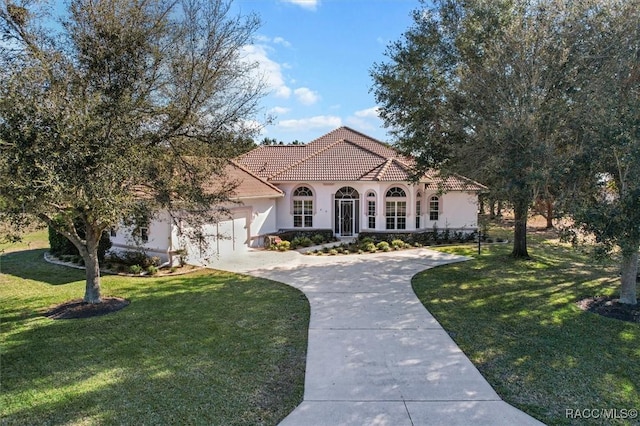 mediterranean / spanish home featuring a front yard, a tile roof, driveway, and stucco siding