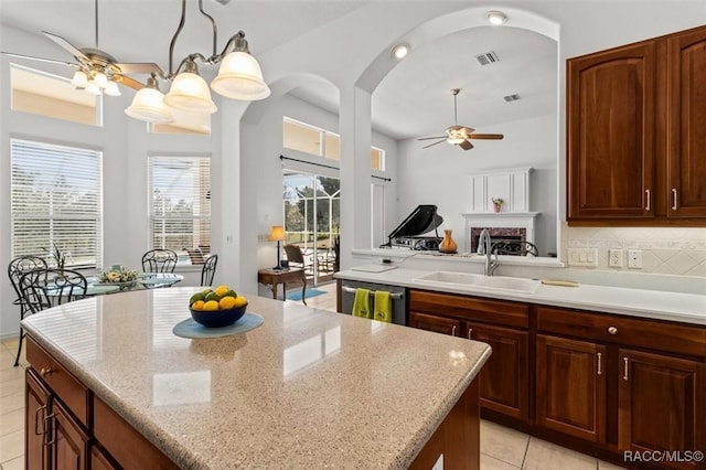 kitchen featuring a sink, visible vents, a ceiling fan, stainless steel dishwasher, and decorative backsplash