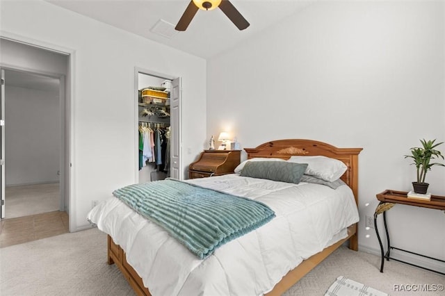 bedroom with visible vents, a ceiling fan, a spacious closet, carpet floors, and a closet