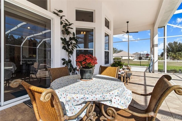 sunroom featuring ceiling fan