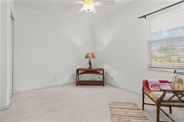 sitting room featuring carpet, a ceiling fan, and baseboards