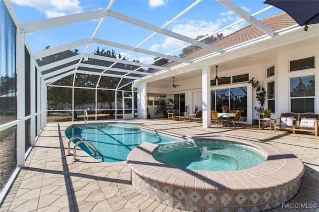 view of swimming pool featuring a lanai, a pool with connected hot tub, a ceiling fan, and a patio