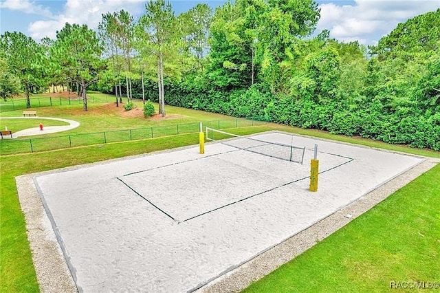 view of community featuring volleyball court, fence, and a yard