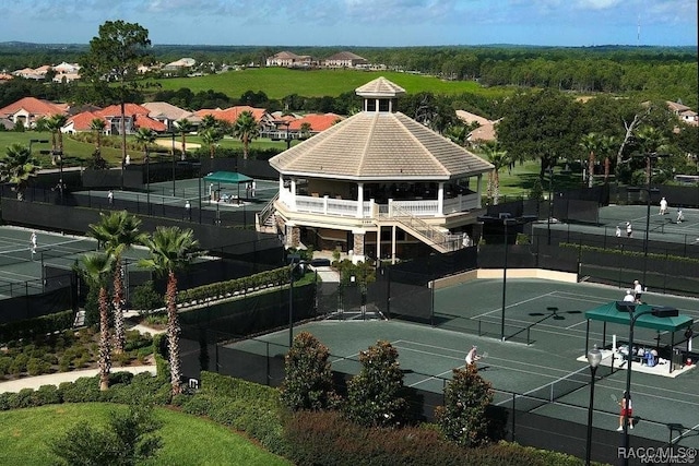 view of sport court with fence and a gazebo