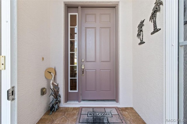 entrance to property with stucco siding