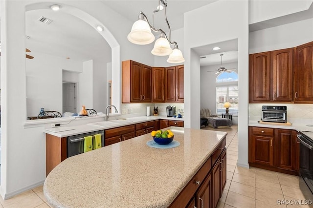 kitchen featuring a center island, visible vents, a ceiling fan, a sink, and dishwasher