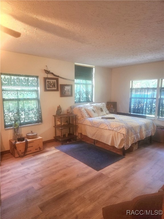 unfurnished bedroom featuring hardwood / wood-style floors and a textured ceiling