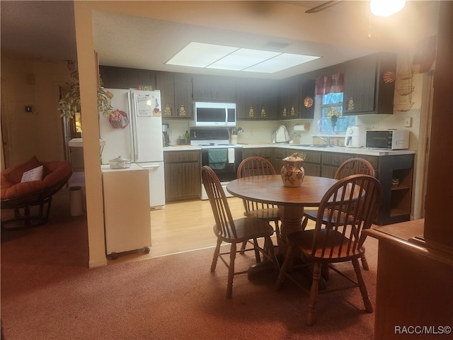 carpeted dining space featuring sink