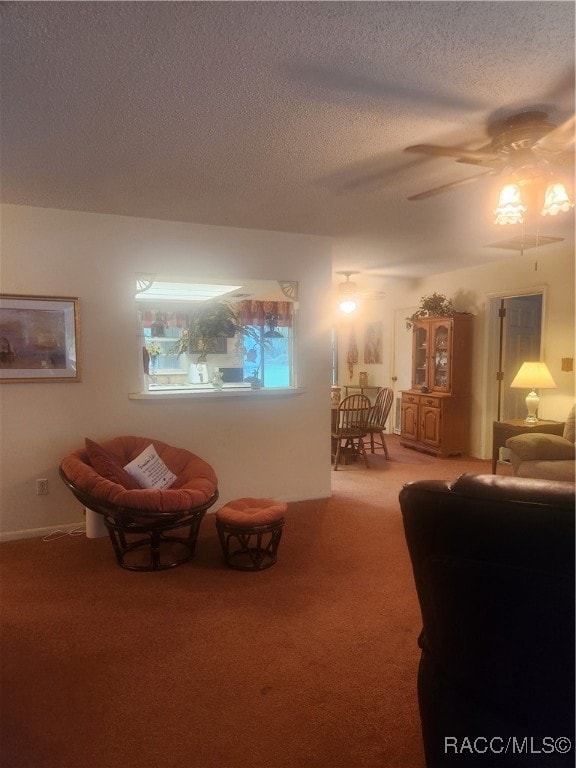 interior space with a textured ceiling and ceiling fan