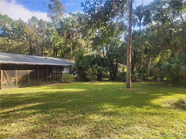 view of yard with a sunroom