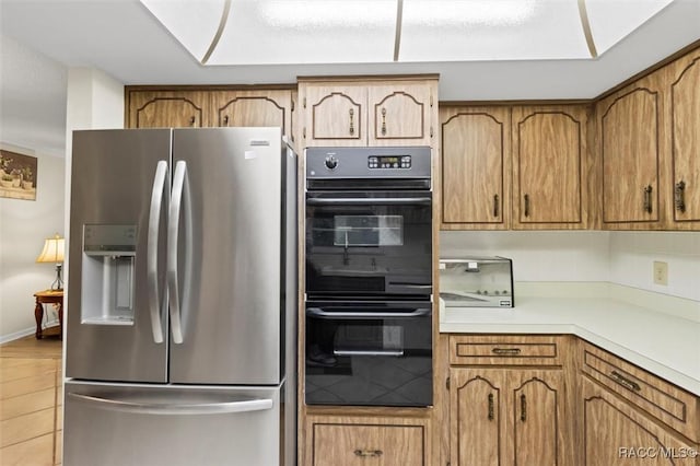 3550 S Dean Ter, Inverness, FL 34452 - kitchen featuring stainless steel fridge, brown cabinets, and light countertops