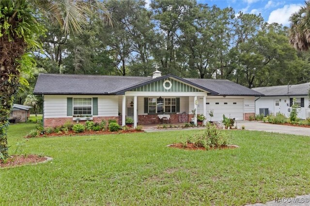 3550 S Dean Ter, Inverness, FL 34452 - single story home with brick siding, driveway, an attached garage, a front lawn, and a chimney