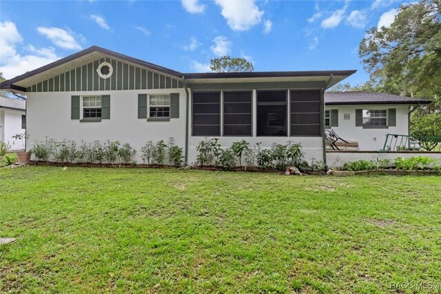 3550 S Dean Ter, Inverness, FL 34452 - back of house with a lawn, stucco siding, and a sunroom