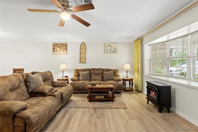 3550 S Dean Ter, Inverness, FL 34452 - living area with a wood stove, light wood finished floors, and ceiling fan