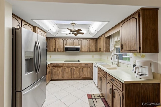 3550 S Dean Ter, Inverness, FL 34452 - kitchen with appliances with stainless steel finishes, a ceiling fan, a tray ceiling, light countertops, and light tile patterned flooring