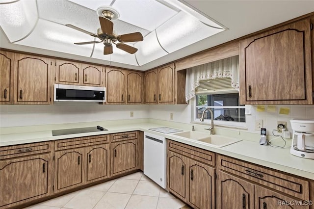 3550 S Dean Ter, Inverness, FL 34452 - kitchen featuring stainless steel microwave, white dishwasher, black electric cooktop, a ceiling fan, and brown cabinets