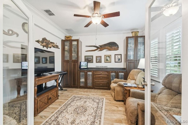 sitting room featuring visible vents, french doors, ornamental molding, and light wood-style flooring