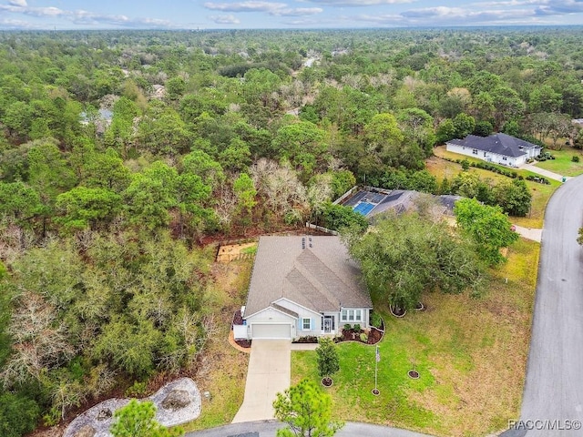 birds eye view of property featuring a wooded view