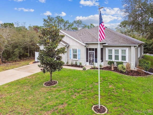 single story home featuring a garage, a front yard, concrete driveway, and roof with shingles