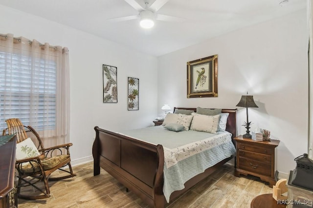 bedroom featuring light wood finished floors, ceiling fan, and baseboards