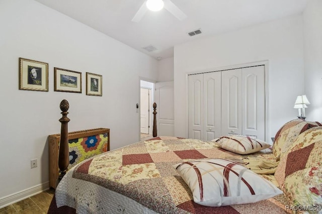 bedroom with dark wood-style floors, ceiling fan, a closet, and visible vents