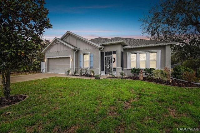 single story home featuring board and batten siding, concrete driveway, a lawn, and an attached garage