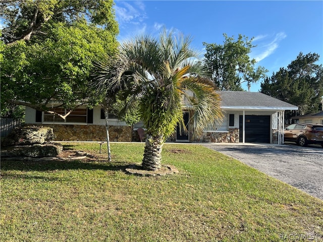 view of front of property with a garage and a front lawn