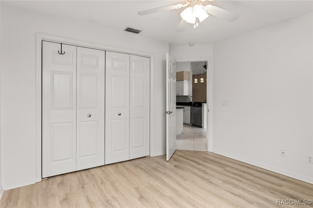 3874 E Lake Todd Dr, Hernando, FL 34442 - unfurnished bedroom with light wood-style flooring, a closet, baseboards, and a ceiling fan