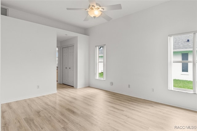 3874 E Lake Todd Dr, Hernando, FL 34442 - empty room with light wood-style flooring, plenty of natural light, a ceiling fan, and baseboards