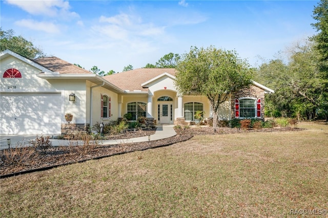 ranch-style home featuring a garage and a front lawn