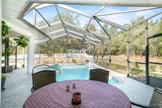 view of pool with a patio area and glass enclosure