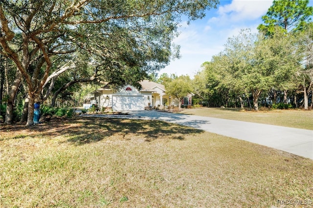 view of front of home with a garage and a front lawn