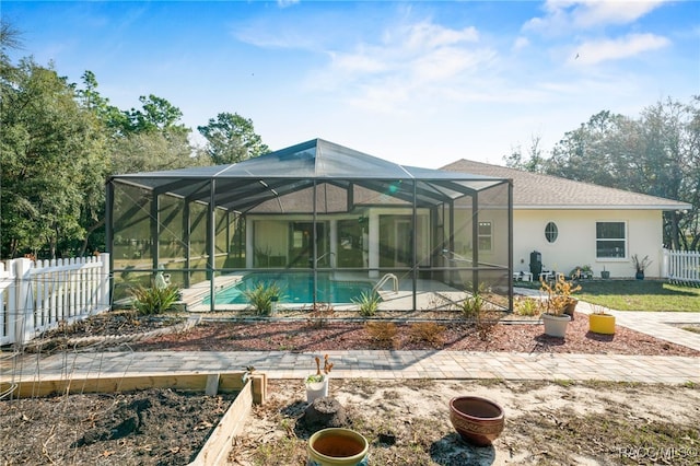 back of house with glass enclosure