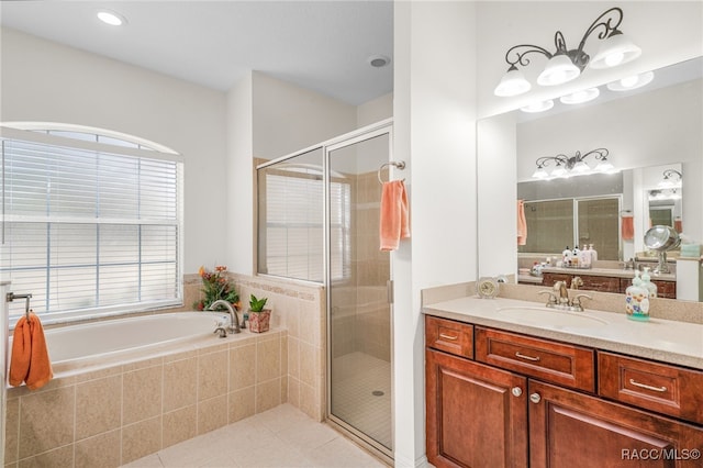 bathroom featuring vanity, shower with separate bathtub, and tile patterned flooring