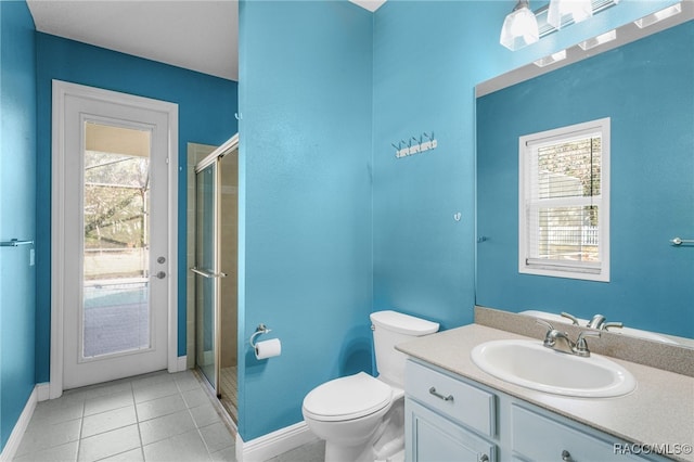 bathroom with vanity, toilet, a shower with door, and tile patterned flooring