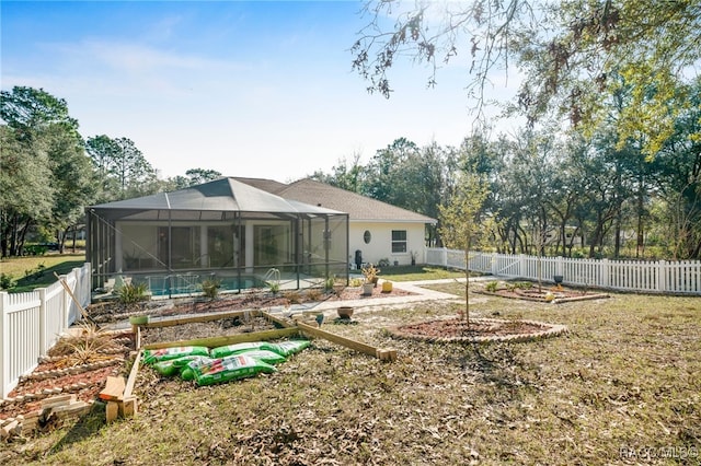 back of house featuring a fenced in pool and glass enclosure