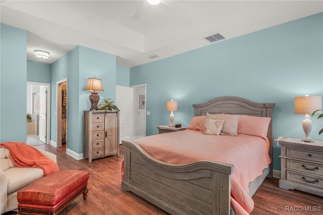 bedroom featuring dark wood-type flooring, ceiling fan, and ensuite bathroom