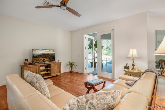 living room with ceiling fan and light wood-type flooring