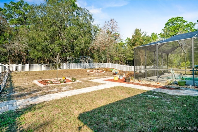 view of yard with a fenced in pool and a lanai