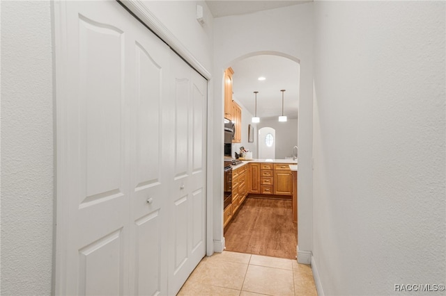 corridor featuring light tile patterned floors