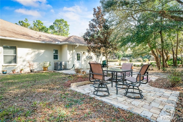 view of yard with central AC and a patio area