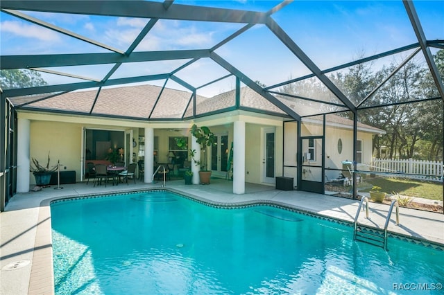 view of swimming pool with a lanai and a patio