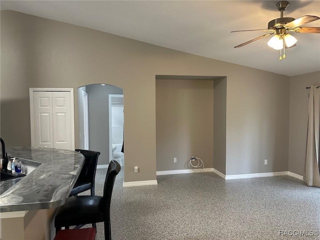 home office with ceiling fan, sink, and lofted ceiling