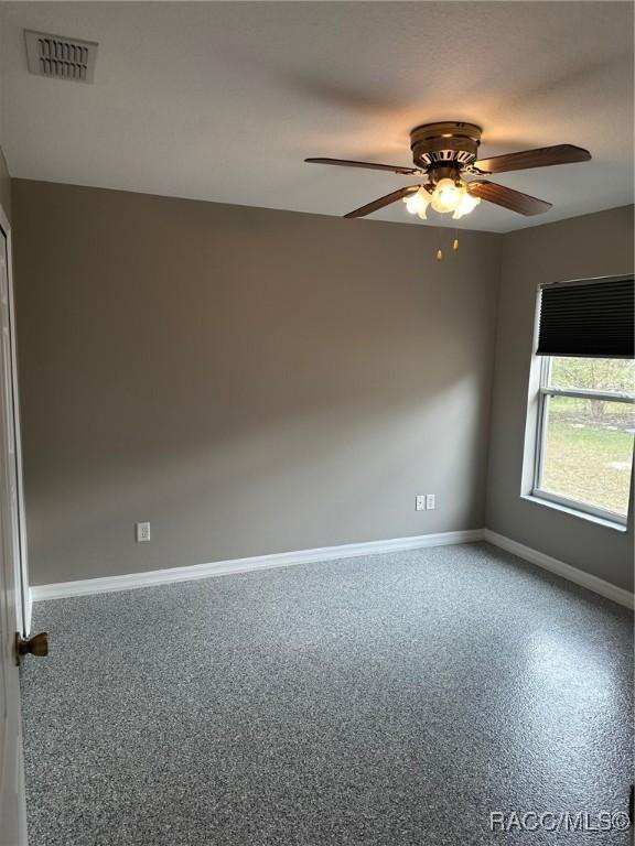 empty room featuring ceiling fan