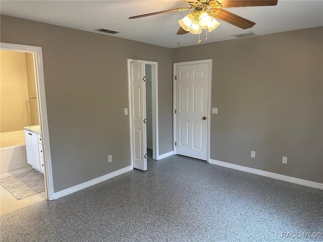 unfurnished bedroom featuring ensuite bath and ceiling fan