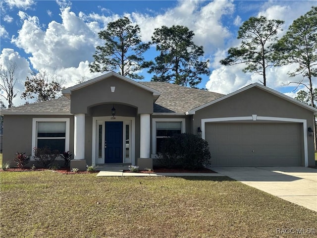 single story home with a garage and a front lawn