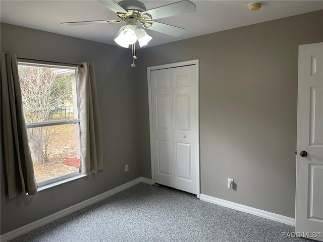 unfurnished bedroom featuring carpet, a closet, and ceiling fan